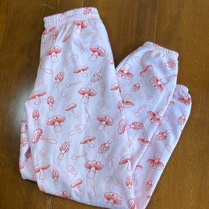 Very comfortable pink sweatpants with cute red mushrooms all over them!